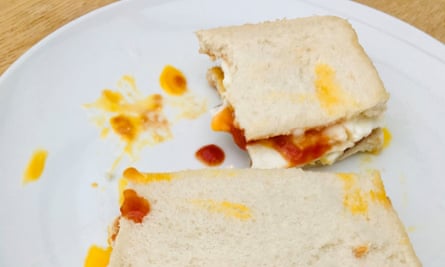 Fried egg sandwich with tomato ketchup.