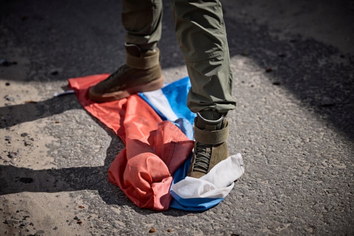 Booted feet on top of a Russian flag
