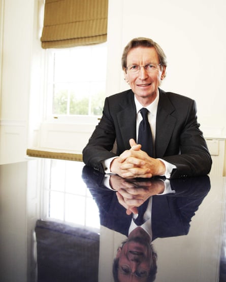 David Montgomery poses at a table with hands folded for a photo