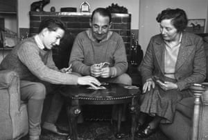 Sixteen-year-old Lester Piggott playing cards with his mother Iris and father Keith, who was a Grand National-winning trainer, at their home in Lambourn in March 1952