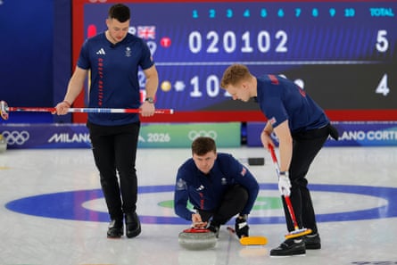 Bruce Mouat of Great Britain (centre) plays a stone.