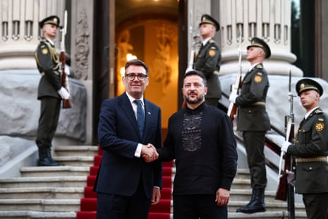 Ukraine’s president Volodymyr Zelenskyy shakes hands with Britain’s prime minister Andy Burnham as they pose for photos.
