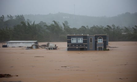 Three people in a flooded house await rescue in Cayey, Puerto Rico