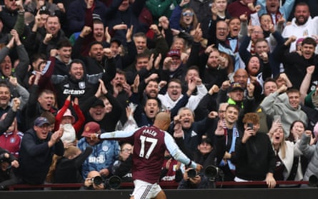 Donyell Malen celebrates scoring his second for Villa against Burnley, watched by cheering fans.