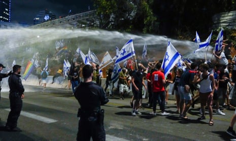Israeli police use a water cannon to disperse demonstrators