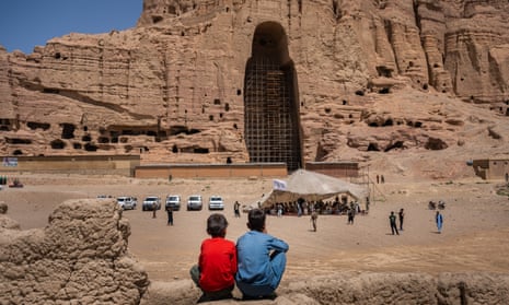 Two boys observe a Taliban conference in front of the ancient and Unesco-protected site of the Buddhas of Bamiyan in Afghanistan.