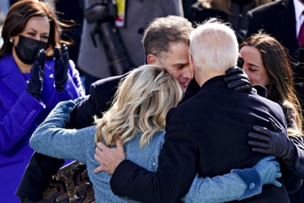Joe Biden is embraced by his son Hunter, the first lady, Jill Biden, and daughter Ashley, during the presidential inauguration in Washington.