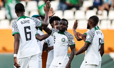 Nigeria’s Moses Simon (centre) celebrates with his teammates after Guinea Bissau’s Opa Sangante turned his cross into this own net and gift Nigeria the lead.