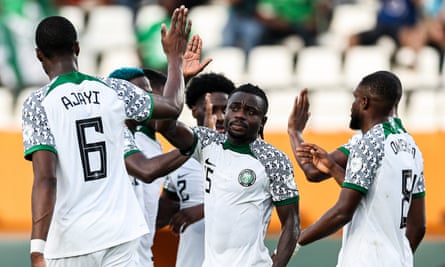 Nigeria’s Moses Simon (centre) is congratulated for his whipped cross that Opa Sanganté was unable to avoid putting into his own goal