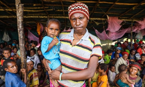 Mother and baby who lost home in PNG earthquake seek refuge in temporary shelter
