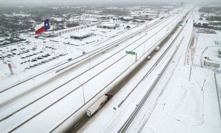 Light traffic moves through snow and ice on US Route 183 in Irving, Texas.