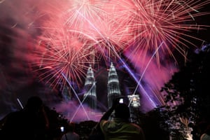 Malaysia’s landmark Petronas Twin Towers framed by the firework display in Kuala Lumpur