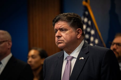 Illinois Gov. JB Pritzker stands with other elected officials.