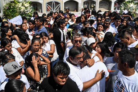 Relatives and friends mourn a 10-year-old dengue victim, Fer Maria Ancajima, at a graveyard in Catacaos district, Piura, Peru.
