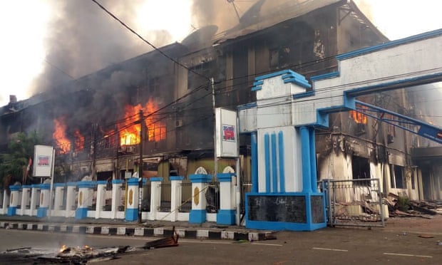 A local parliament building burns during a protest in Manokwari