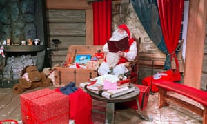 Santa Claus in his chamber behind a plexiglas screen in the village of Rovaniemi, Finland