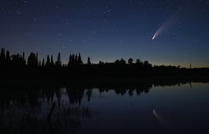 Neowise streaks across the night sky over Wolf Lake in Minnesota, US