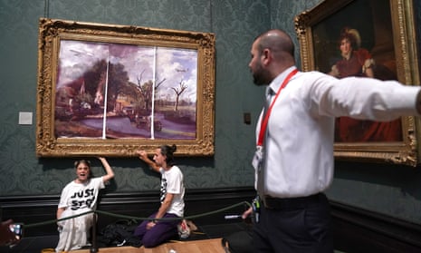 Just Stop Oil protesters glue their hands to the frame of John Constable's The Hay Wain at the National Gallery, London. 