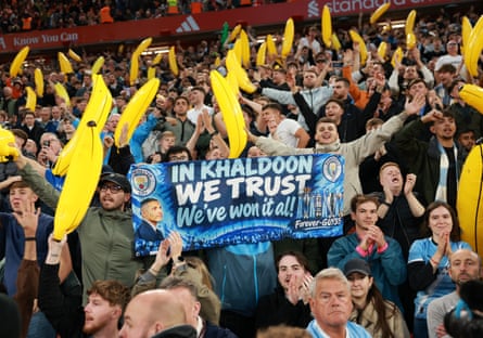 Manchester City fans holding a banner and inflatable bananas.