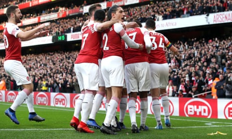 Arsenal players celebrate Pierre-Emerick Aubameyang’s opening goal as a banana skin is thrown on to the pitch.