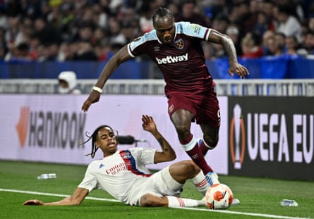 Lyon’s forward Bradley Barcola (L) tackles West Ham’s midfielder Michail Antonio during their Europa League quarter-final in 2022