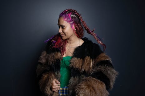 Woman wearing fur coat with pink braided hair