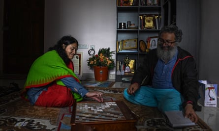 Sharmila and Coutinho play Scrabble in the living room of their apartment on the outskirts of Bangalore.