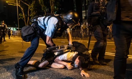 A protester is detained during a clash after a rally against the extradition law on Sunday.