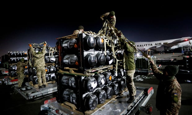 Ukrainian service members unpack Javelin anti-tank missiles, delivered by plane as part of a US military support package