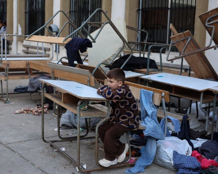 A child sits inside a girls high school, turned into a shelter for displaced people in Tyre, Lebanon.