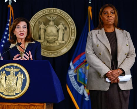 Kathy Hochul speaks into a microphone next to Letitia James