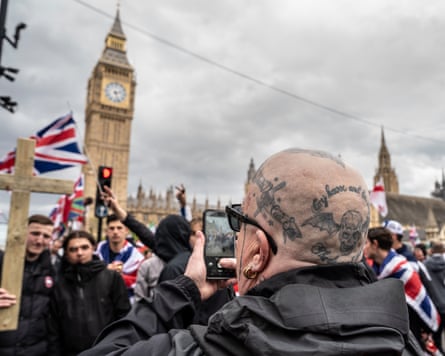 A man takes a photo of the crowd assembled in front of Big Ben