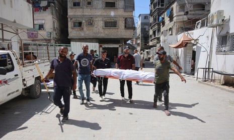 Palestinians carry the body of a person killed in an Israeli strike in the Jabalia refugee camp, northern Gaza, on Saturday