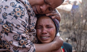 Nokulunga Mbangi is comforted by her sister-in-law Sophie Mofali after being told that her husband Isaac Mofali had been killed by the Red Ants.