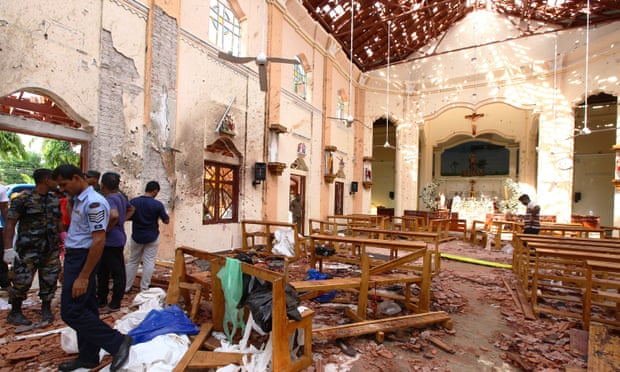 Sri Lankan officials inspect St Sebastian’s church in Negombo, north of Colombo, after a suicide bombing.