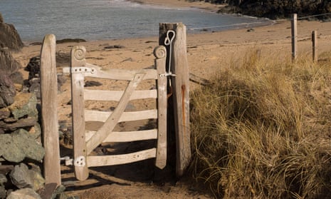 A charmingly hand-carved gate leading to a beautiful beach