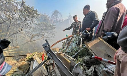 Rescuers gather at the site of the plane crash in Pokhara