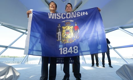 Foxconn chairman Terry Gou, left, and governor Scott Walker hold the Wisconsin flag to celebrate the company’s $10bn investment to build a display panel plant in Wisconsin.