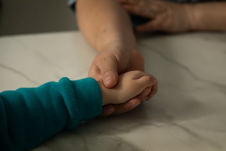 a women holding a child hands