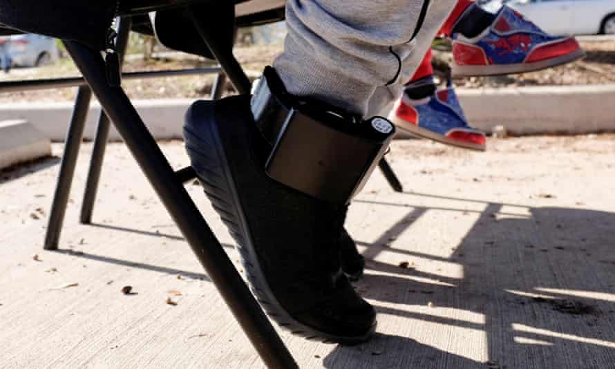 man’s foot with ankle monitor
