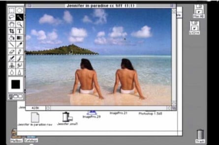 Computer screen showing a duplicated woman in white bikini bottoms, back to camera, sitting on a sandy beach looking out to sea, blue sky and an island ahead of her