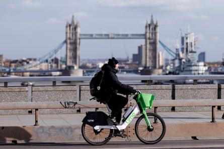 A Lime rental electric bike in central London, with Tower Bridge in the background.