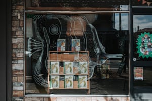 A transparent fish is seen on the window of a bookstore, with books on display visible through it