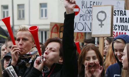 Polish women and some male supporters blow horns while raising a coathanger, a symbol of illegal abortions, during a protest in Warsaw last October.