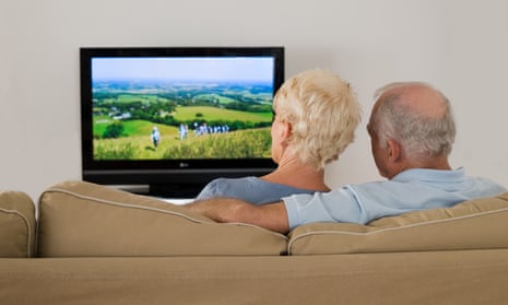 An older couple watching TV