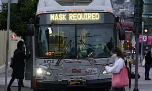 A sign on a bus in San Francisco advises that passengers are required to wear masks.