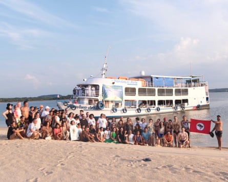 Indigenous leaders, forest defenders, artists and scientists board the Sumaúma boat to COP30 after a traditional inauguration ceremony on the shore of the Amazon river.