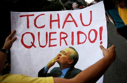 A protester holds a sign that reads “Bye Darling” to Renan Calheiros, during an anti-corruption demonstration in São Paulo.