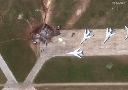 satellite image of an exploded plane on a runway near other planes