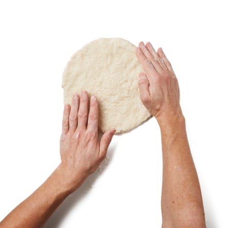 Liberally flour a work surface and your hands, then tip out the dough and form it into a roughly 2cm-thick round.